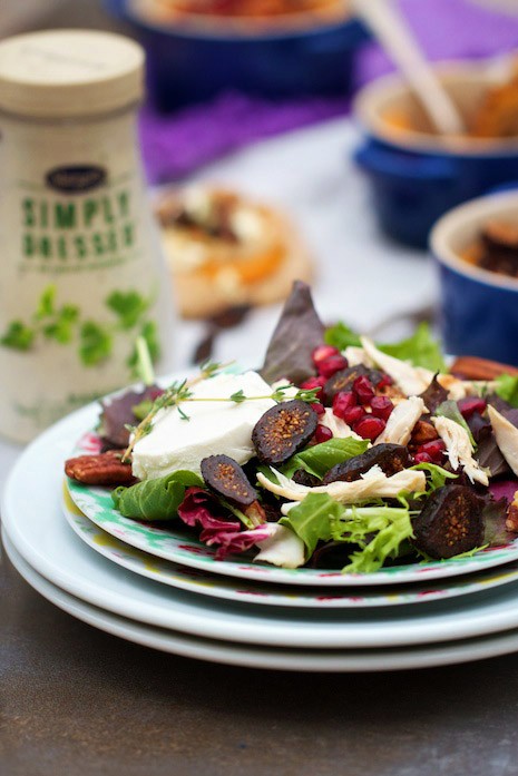 Salad with goat cheese, turkey, pomegranate seeds and pecans.